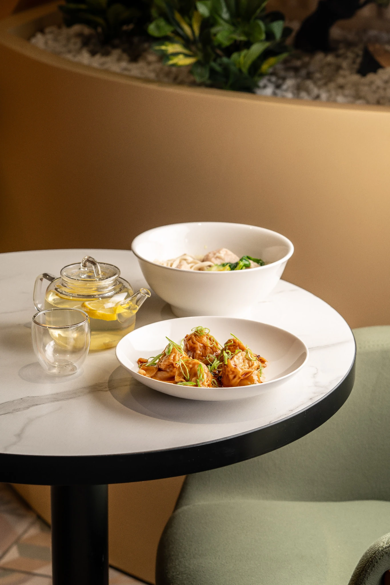 Dumplings, noodle soup and tea on a café table